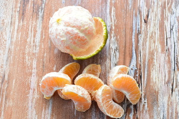  Natural, whole, chopped tangerines on wooden background