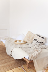 Cozy bedroom decor, a pair of white cups on a wooden bed, beige bedspread and blanket, comfort, cosiness, hugge, flat lay