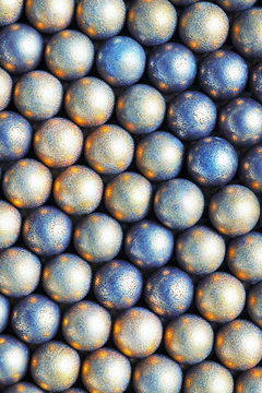 The surface of the many balls of light yellow and blue. Abstract festive background or wallpaper. View from above. Vertical shot. Macro