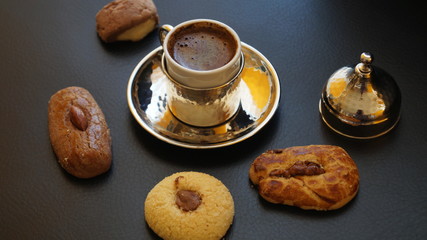 Turkish coffee and traditional cookies - kurabye on a black background