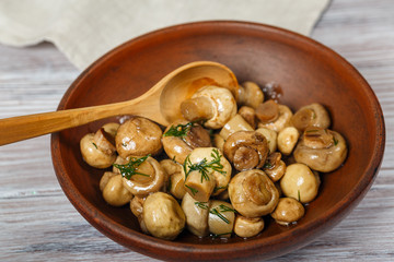 Clay bowl with pickled mushrooms