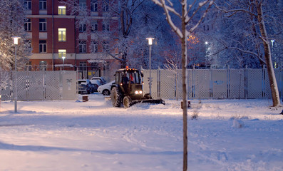 Clearing snow from the road.
