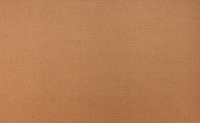 Texture of brown recycled corrugated cardboard with small inclusions
