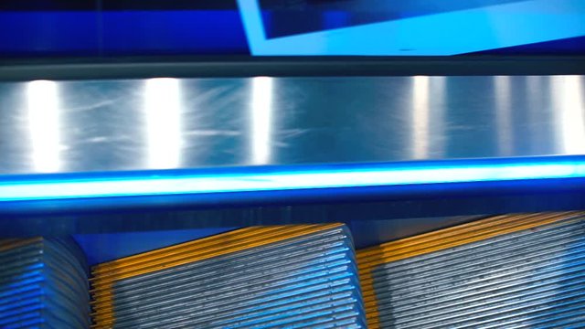 The smooth movement of the escalator in the entertainment center.