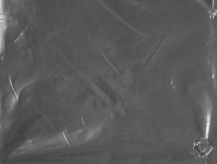 Background texture of a polyethylene transparent film on a grey background