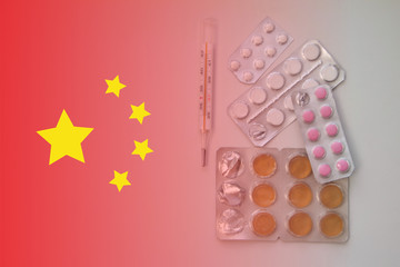 Chinese flag on background of pills and thermometer: pandemic virus infection from Wuhan, China, novel Coronavirus outbreak.