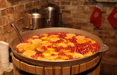 Large cauldron with tasty mulled wine at winter fair