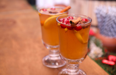Tasty aromatic mulled wine on wooden table