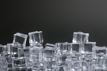 Crystal clear ice cubes on black background