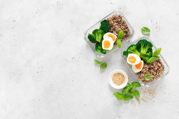 Lunch boxes with broccoli, quinoa and egg, healthy  food, balanced eating concept, top view