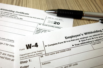 Obraz premium Blank W-4 form and a pen. Tax season