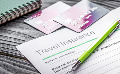 booking travel concept with insurance on wooden table background