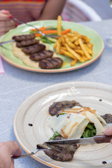 Grilled minced meat stakes served with french-fries and sauce