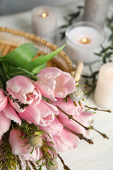 Beautiful bouquet with spring pink tulips on table, closeup