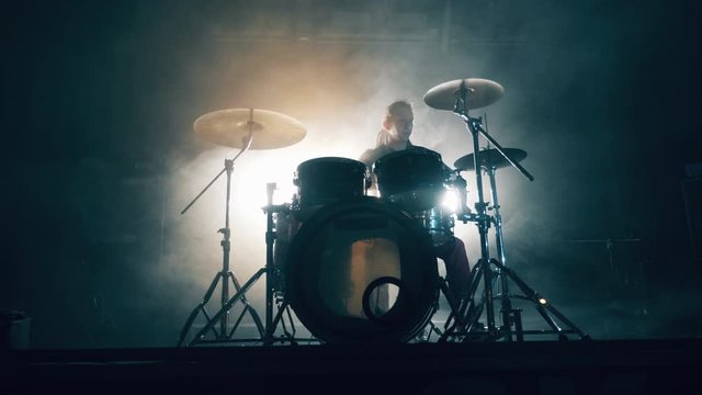 Professional musician is playing drums during concert rehearsal