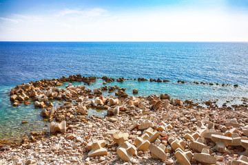 Fototapeta na wymiar Huge boulders on the beach in Petrovac bay, on the coast in Montenegro
