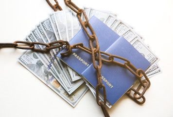 Passport and money in old rusty chains. Arrested for illegal immigration. Broken the law. Smuggling concept.