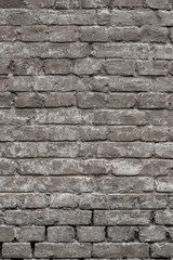 Old vintage shabby brick wall with peeling plaster. Grungy loft texture, background.