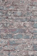 Old vintage shabby brick wall with peeling plaster. Grungy loft texture, background.