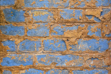 Old vintage shabby brick wall with peeling plaster. Grungy loft texture, background.