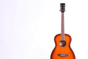 Obraz premium Folk style parlor acoustic guitar isolated on white background with a lot of copy space for text. Studio shot of travel size musical instrument. Close up.