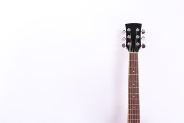 Fototapeta premium Folk style parlor acoustic guitar isolated on white background with a lot of copy space for text. Studio shot of travel size musical instrument. Close up.