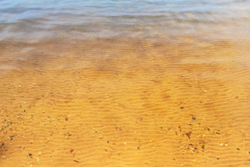 Sandy bottom on the lake with clear water