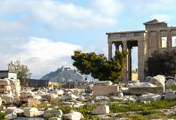Ancient Erechtheion temple on Acropolis hill in Athens, Greece with pillars and statues, soft focus.