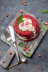 Red velvet pancakes with cream cheese sauce.