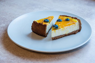 Grey plate with two pie of homemade cake with berry decorate on top