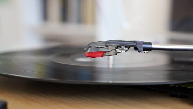 Disc turning on a turntable while the stylus lowers on it