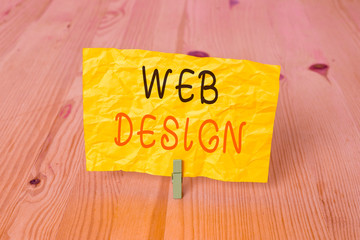 Conceptual hand writing showing Web Design. Concept meaning Website development Designing and process of creating websites Wooden floor background green clothespin groove slot office