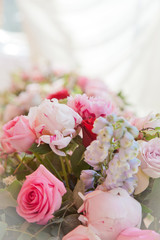 beautiful bouquet of peonies and other pink flowers with wedding rings for newlyweds