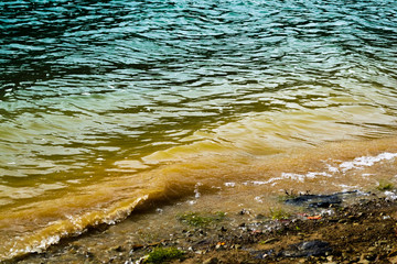Close view of the waves on shore of Doftana river