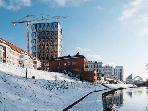 Modern view of the Yekaterinburg city with a Iset river and embankment along the river. Contemporary building construction place