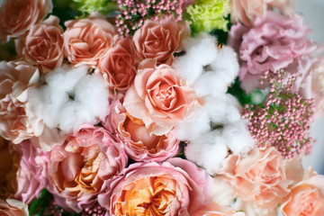 Delicate bouquet of eustomas, carnations, cotton, spray roses and David Austin roses, in pink and beige colors. - 318668598