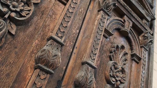 Slide shot of an old wooden door of a beautiful ancient building. Wood texture doors. Close up 4k