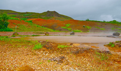 Hot volcanic springs Blesi around famous Strokkur geysir in National Park on Iceland with beautiful...