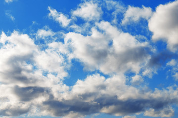 Amazing beautiful fluffy cumulus clouds on a blue sky. Abstract natural background