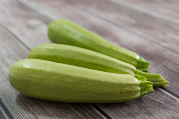 Fresh zucchini on wooden background