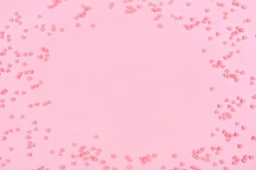 Pink background with tiny hearts. Valentine's day concept. Top view.