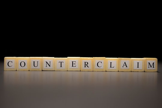 The word COUNTERCLAIM written on wooden cubes isolated on a black background...