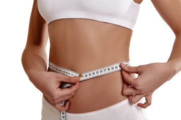 Perfect, slim, young body of a girl in white underwear. The girl measures the waist. Weight loss and healthy eating. The problem of anarexia. Plastic surgery.