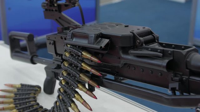 Machine gun weapon large caliber bullets bandolier belt military camera movement
