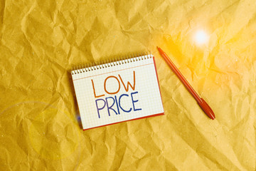 Writing note showing Low Price. Business concept for Price are the lowest in relation to other...