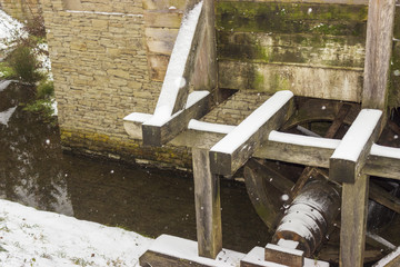 Old watermill with pulverized water wheel