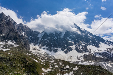 Aiguille du Midi among the clouds. Mont Blanc massif. Alps.