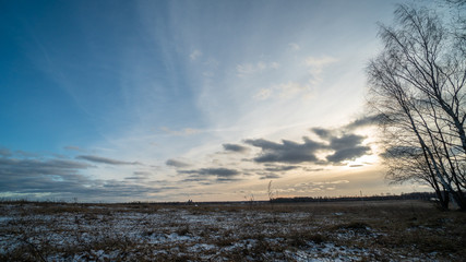 Beautiful setting sun over frozen field
