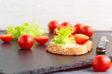 Fototapeta na wymiar Sandwiches with soft cheese, lettuce and tomatoes on grain bread.