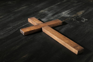 Christian cross on dark wooden background